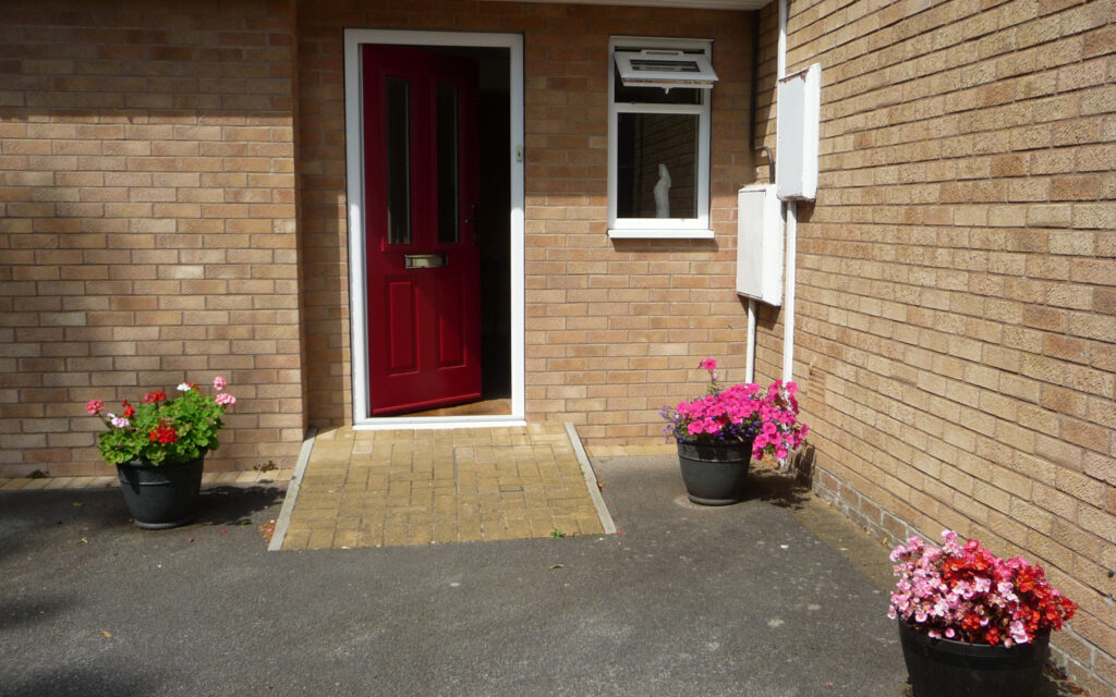 Click to enlarge Summer flowers welcoming visitors by the front door